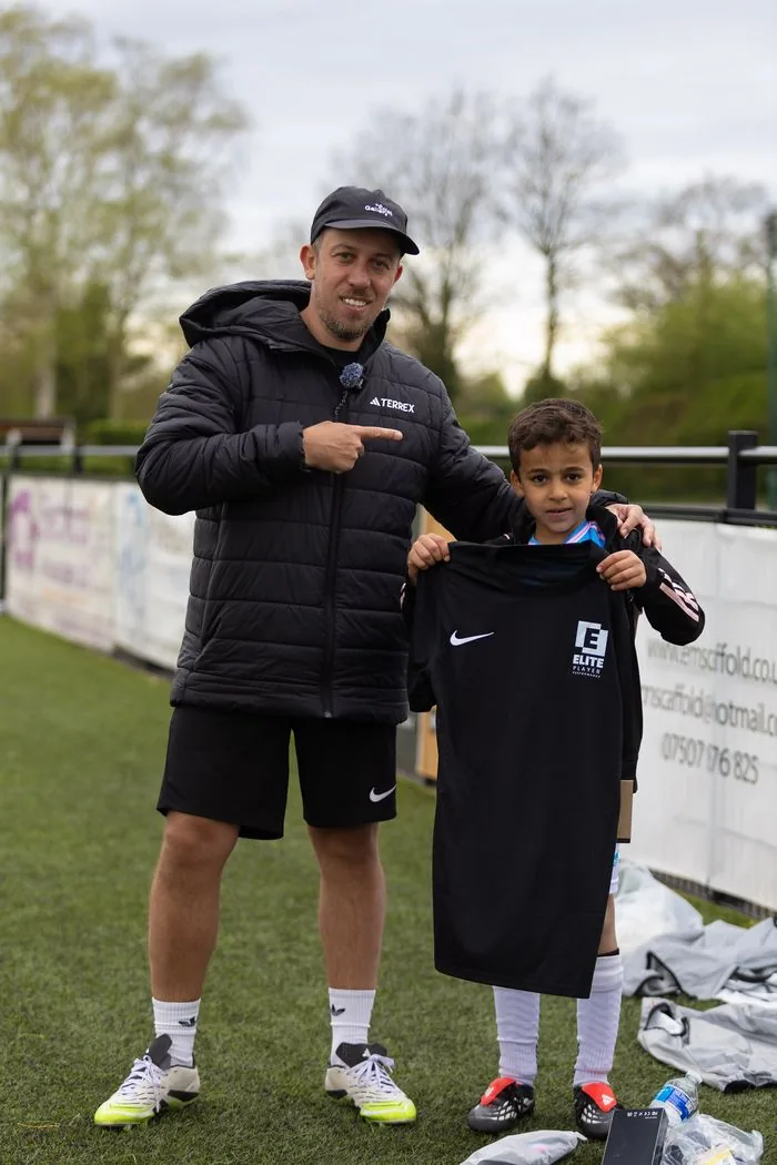 Ben Royal presenting young athlete with EPP Nike kit after completing initial assessment assessment session at Elite Player Performance Birmingham