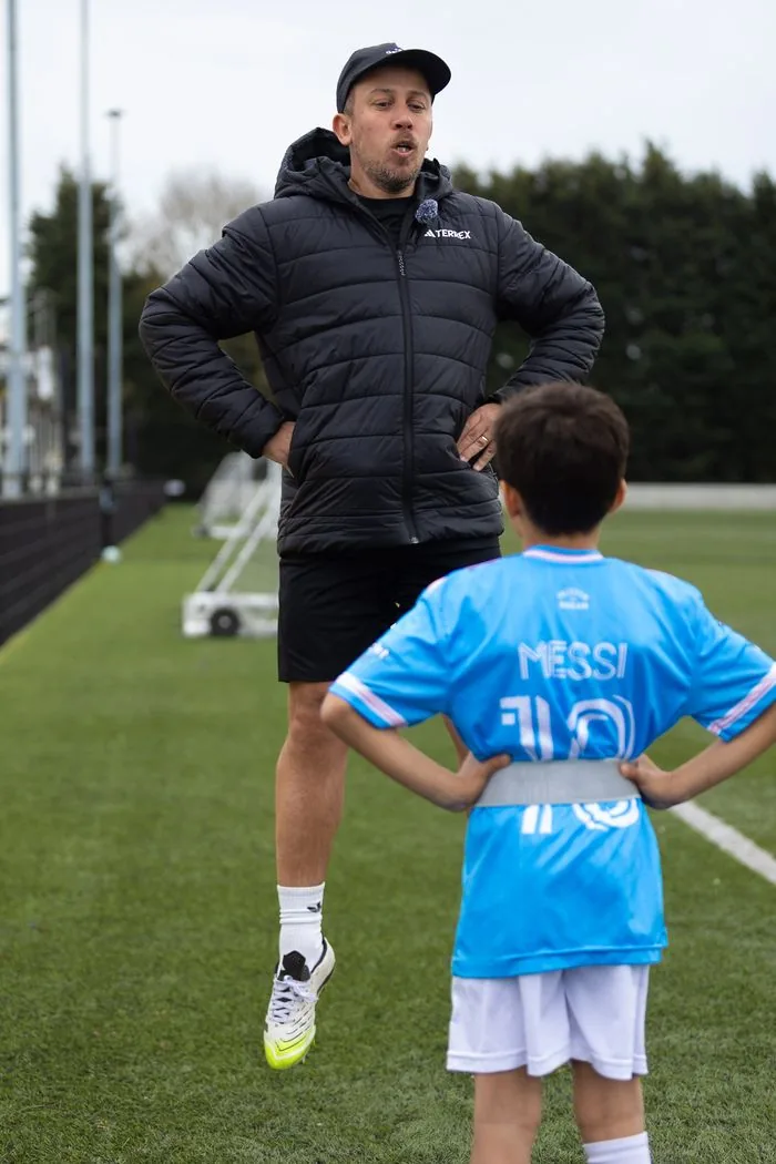 Ben Royal demonstrating movement technique to young athlete at EPP initial assessment session